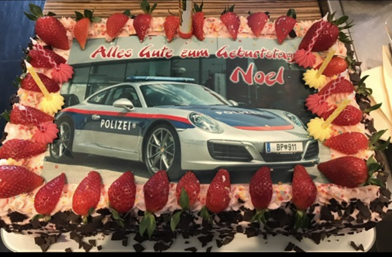 Rectangular photo cake with a car design and strawberries