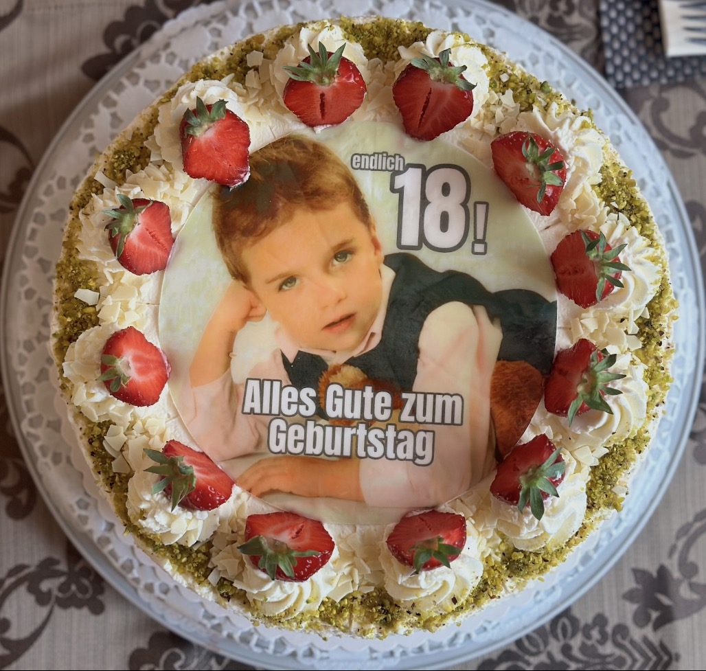 18th birthday photo cake with a personal photo and strawberries